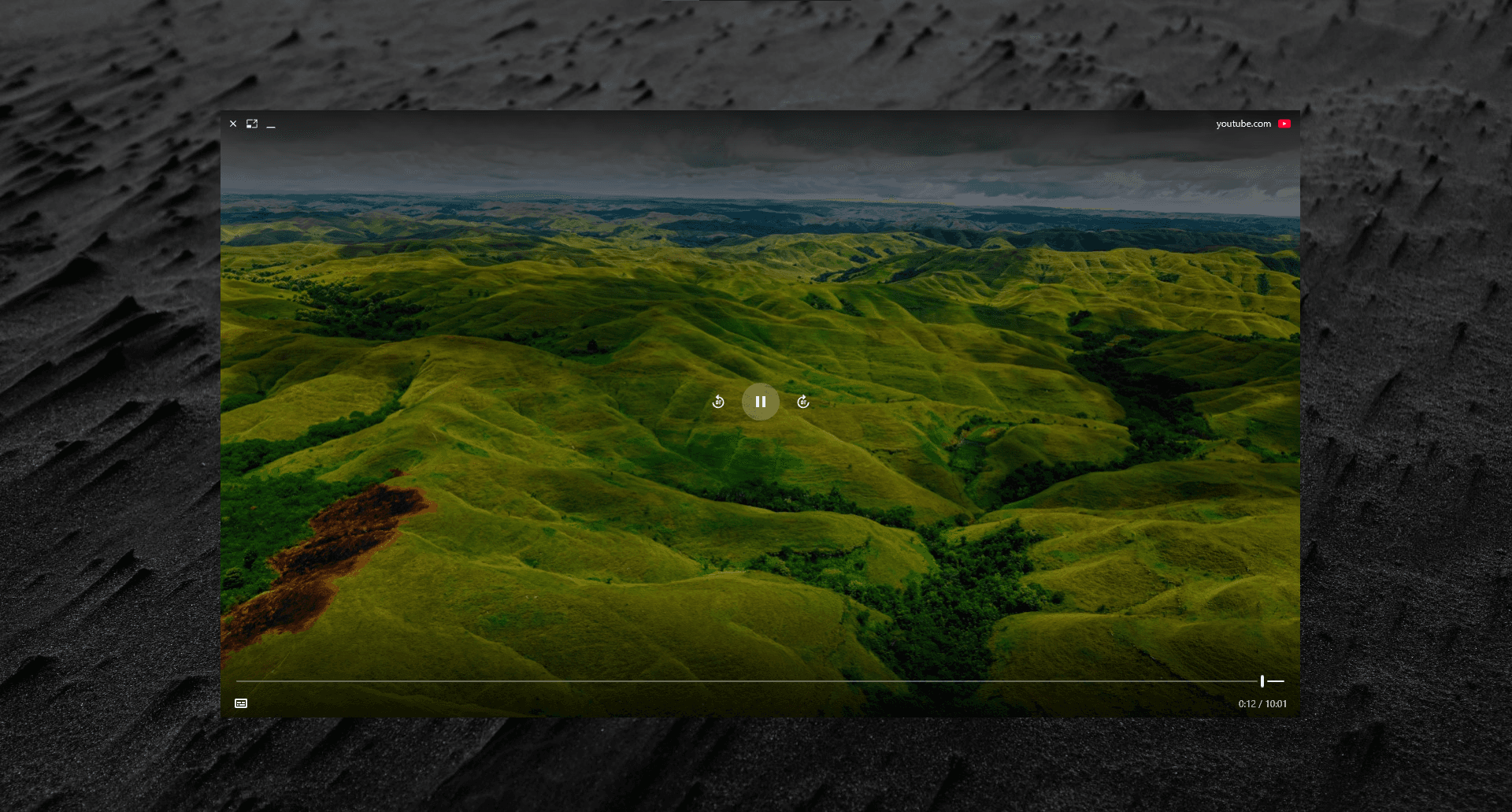 A YouTube video floating above the desktop in Peekly's Float window, outside the browser entirely